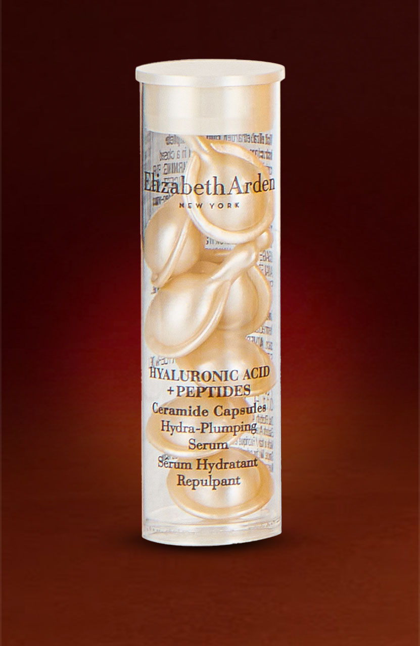 A cylindrical container of Elizabeth Arden Hyaluronic Acid and Peptides Ceramide Capsules against a dark red background.